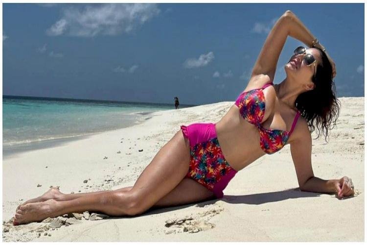 Sunny Leone Was Seen Draped In The Sand By The Seaside, Wearing A Pink Bikini Set On Fire